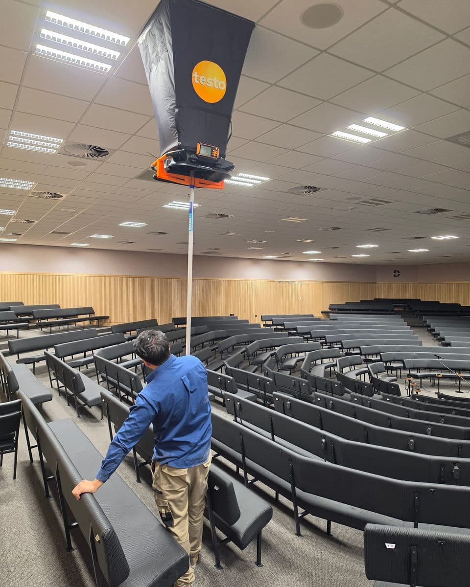 Close view of the hood extension base measuring a high auditorium ceiling outlet