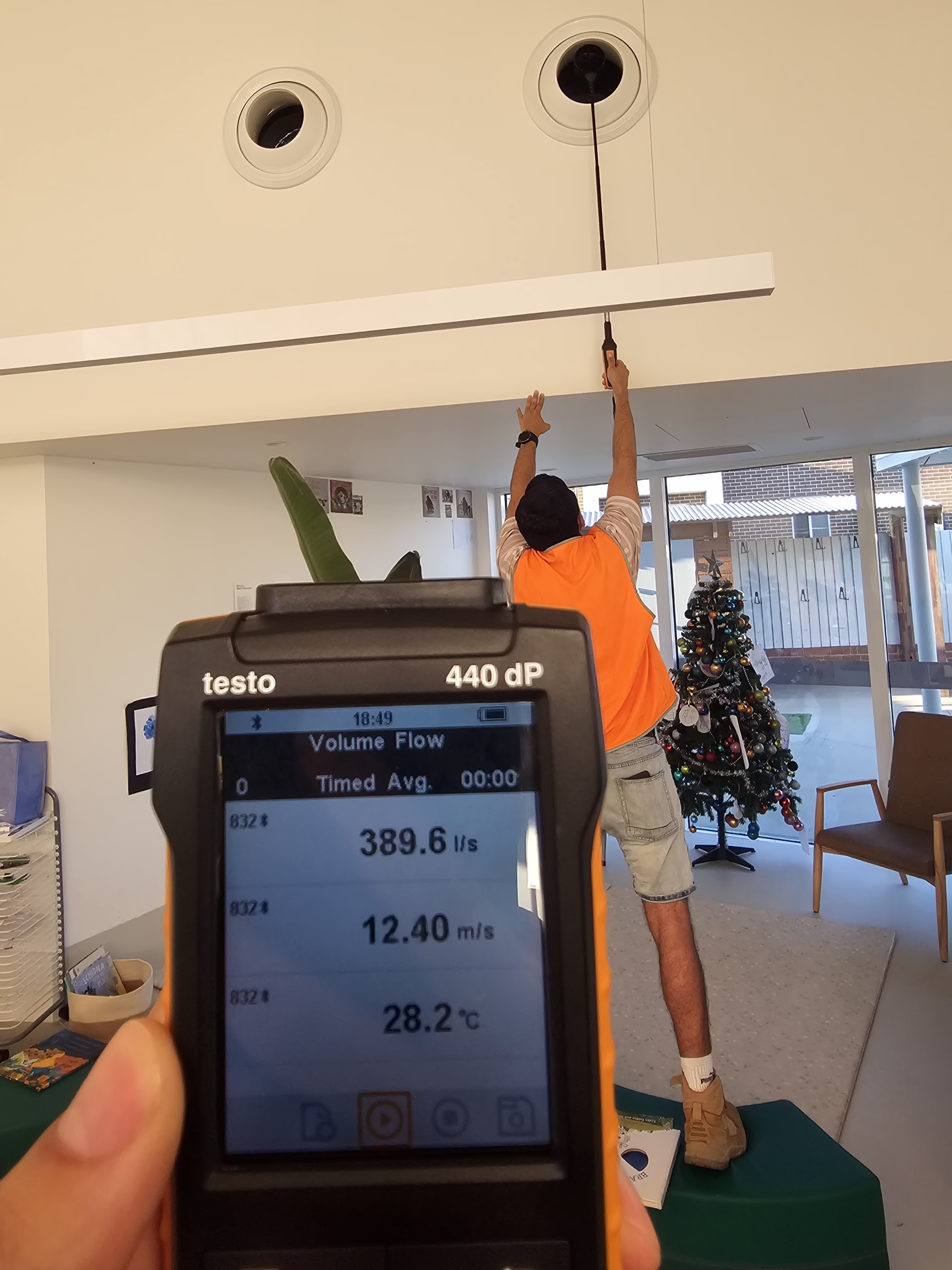 "Energy Recovery Ventilator (ERV) installation showing ductwork, connections, and mechanical components in ceiling space